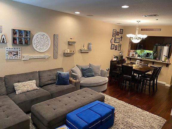 Living room with view of dining area and kitchen with counter (note: counter allows for 3 counter stools)