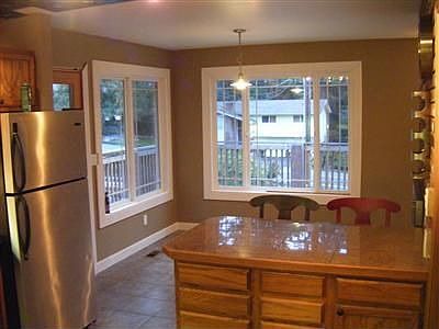 Eating Area off of Kitchen, with Breakfast Bar and Two Sided Fireplace