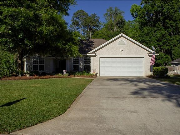 Enjoy the beautifully landscaped front lawn of this move-in-ready home