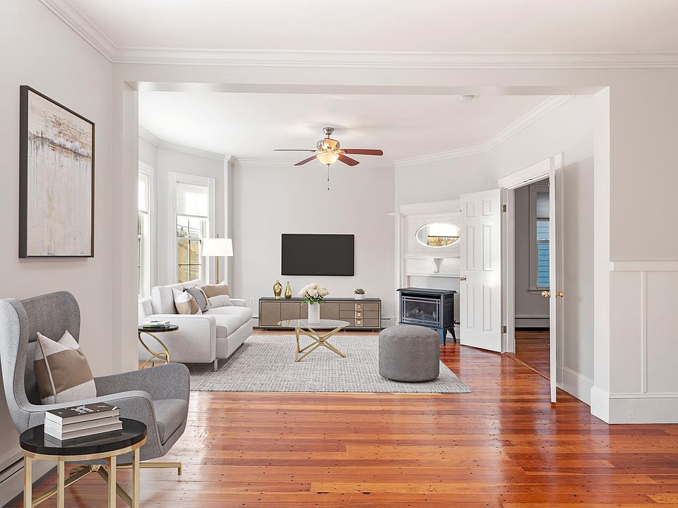 Living Room - Includes gas stove and an abundance of natural light. Connects to dining area.