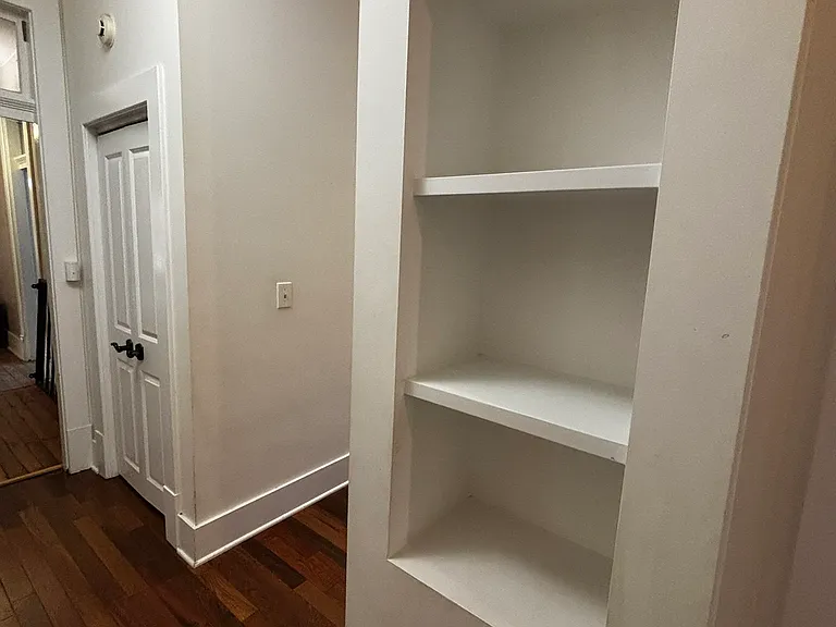 Hall coat closet (left) and built-in shelves