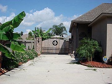 Custom ironwork fence and tropical landscaping