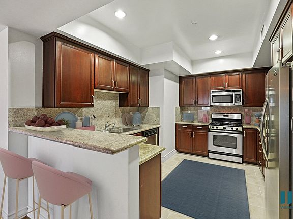 Full-Size Kitchen with Stainless-Steel Refrigerator, Stove, Microwave Oven, and Dishwasher