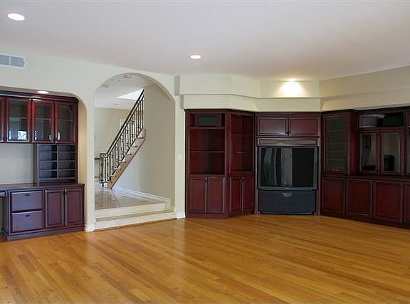 Family Room features Built Ins and Hardwood Flooring