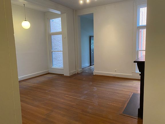 Living room area with historic fireplace mantle