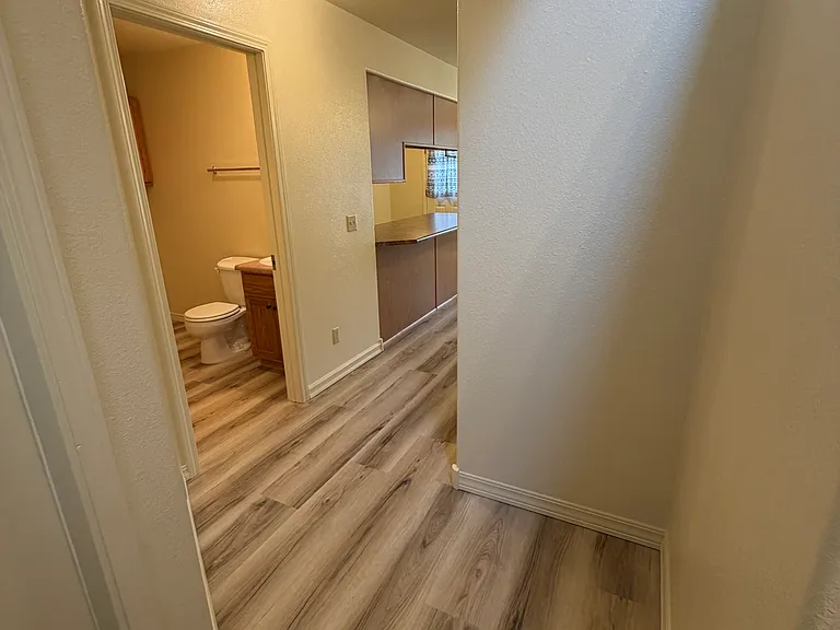 Front entrance hall leading to laundry room, living room, dining room, and kitchen.