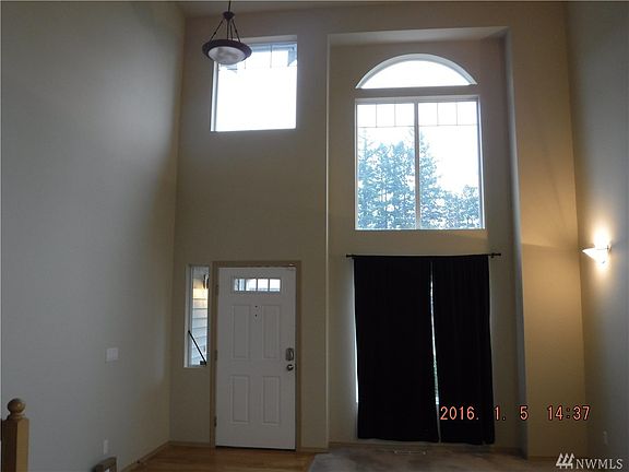Vaulted ceilings in light filled entry way and attached dining room.  Currently rented some of the pics are from prior to occupancy of renter.