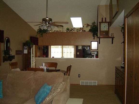 This view from the living area looks toward the kitchen with the large pass-through that creates a nice convenience from kitchen to dining room.