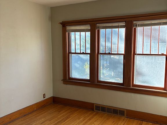 Beautiful dining room with original light fixture and hardwood floor