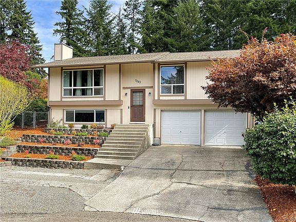 Beautiful mature landscaping, extra parking in the gravel area.