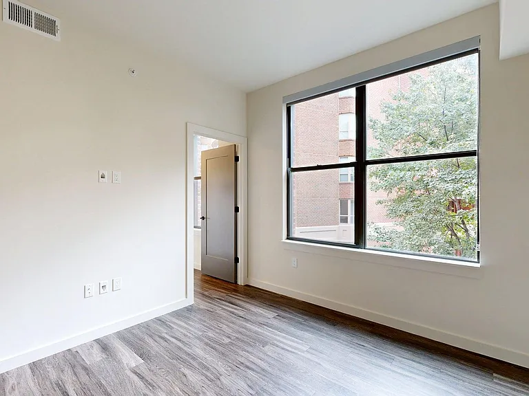 Spacious apartment Bedroom with Wood Style Flooring.