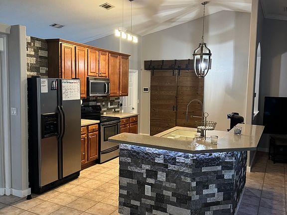 Kitchen features stainless steel appliances, Corian solid surface counter tops, room for a breakfast nook table, plenty of cabinetry, and a large pantry.