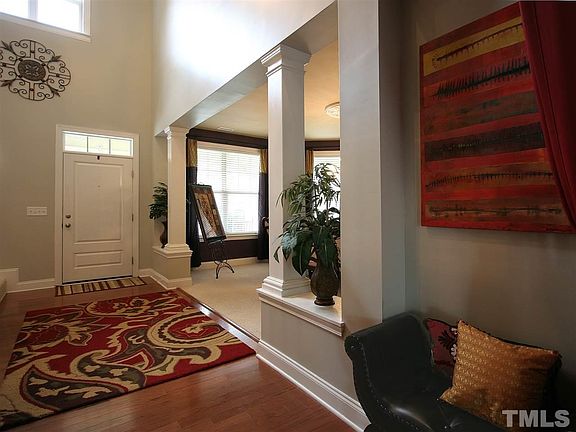 Elegant foyer greets you and your guests. Hardwood floor. Soaring ceiling. Stately columns provide visual separation to the dining room.