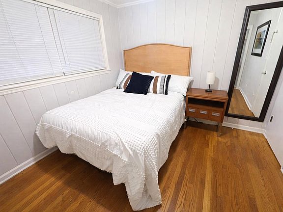 Queen bed, 2 windows, and a wall mirror