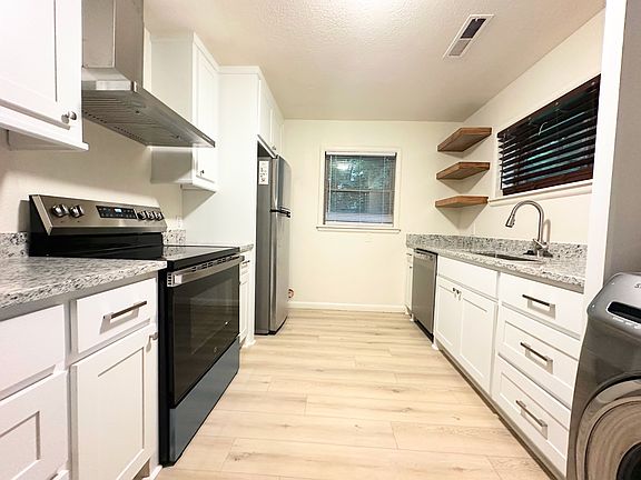 Brand new custom kitchen cabinets, granite counter tops, appliances, fixtures, and new flooring throughout.