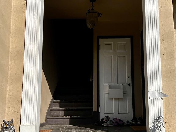 Archway to front doors, and basement door. Each unit has a private key locked mailbox in the entryway.