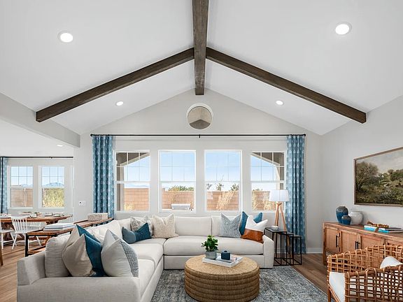 Great room with vaulted ceiling and stained-ceiling beams