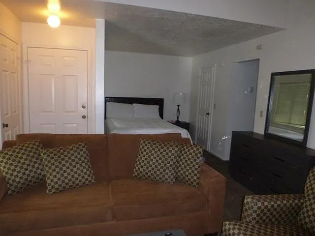 View From living area to sleeping alcove, hallway to bathroo