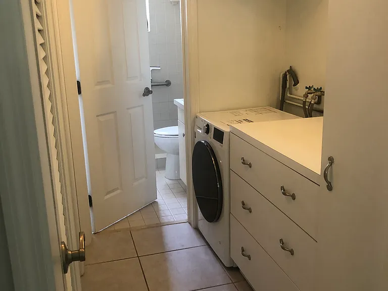 Laundry with new Washer/Dryer combo plenty of storage and folding area.