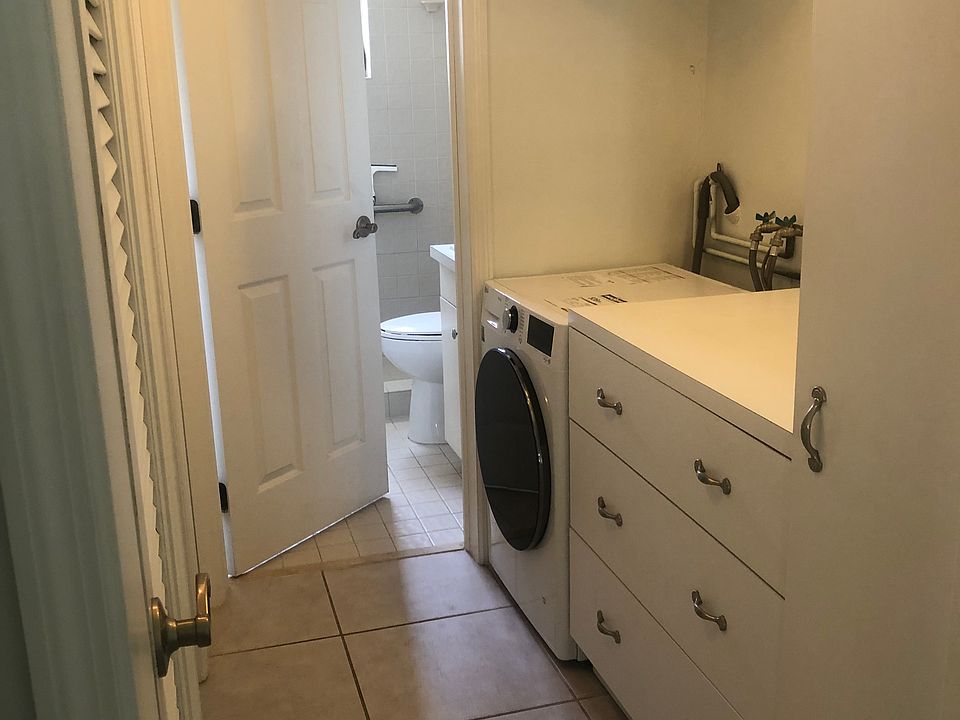 Laundry with new Washer/Dryer combo plenty of storage and folding area.