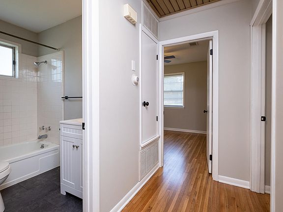 Hallway leads to full bath and linen closet