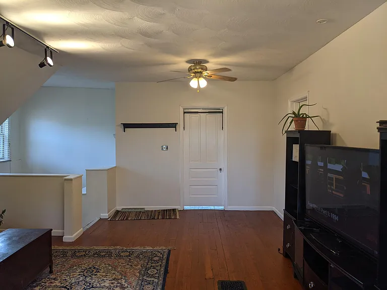 Third floor living area looking towards third floor bedroom.