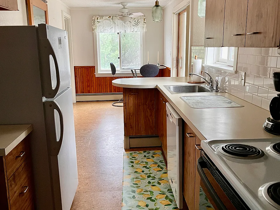 Efficient Kitchen with a view to the backyard while doing dishes!
