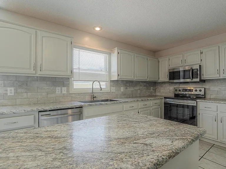 The large kitchen features lots of counter space and high-end appliances.