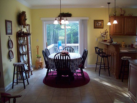 Roomy dining room and breakfast bar open easy mobility between dining, kitchen