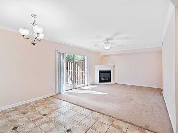 View from kitchen dining area looking into livingroom - corner gas fireplace - large sliding glass patio doors.
