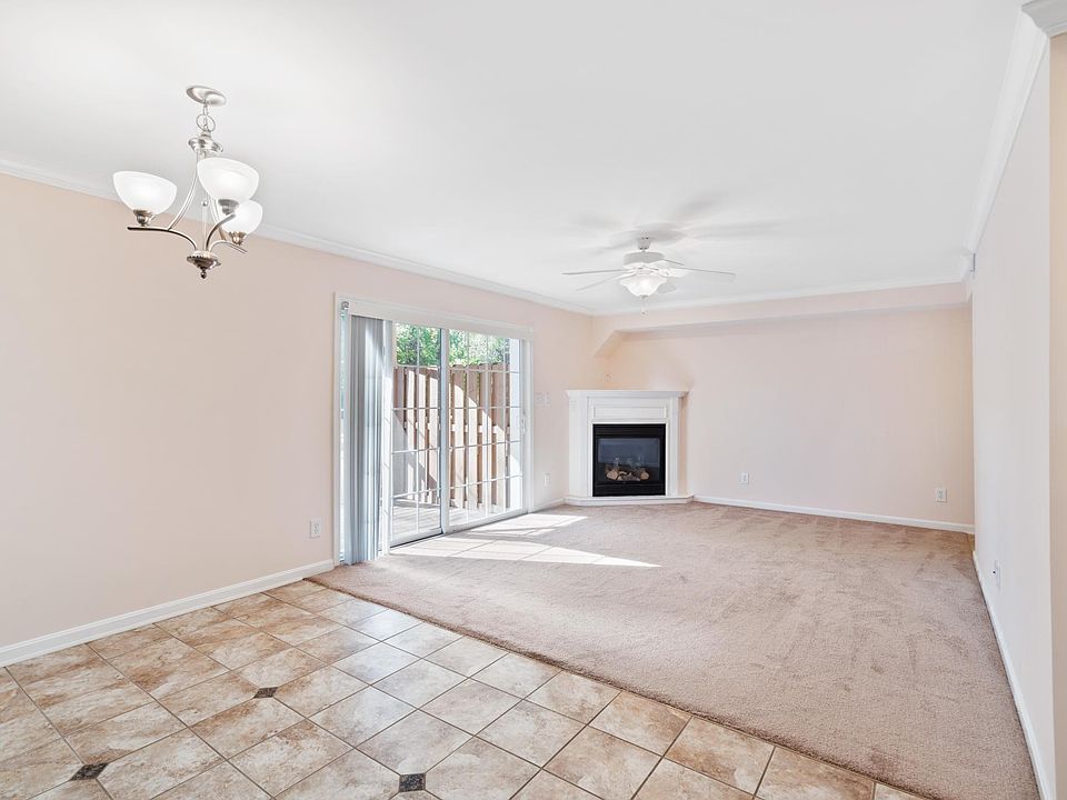 View from kitchen dining area looking into livingroom - corner gas fireplace - large sliding glass patio doors.