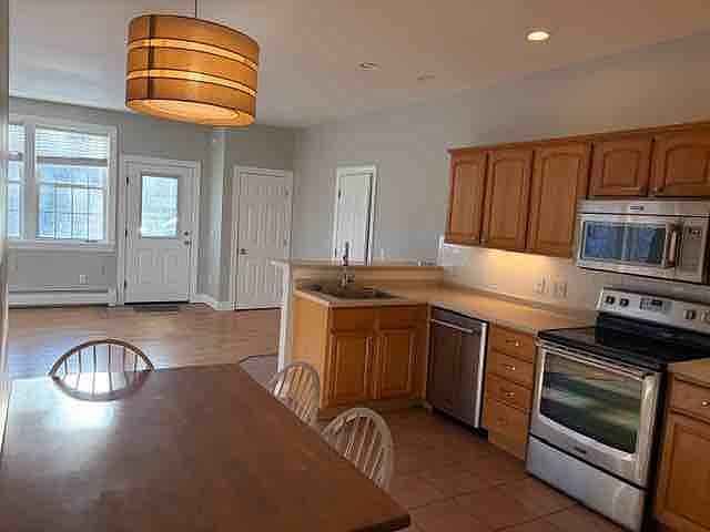 Kitchen looking into living area, half bath door on right and entry closet.