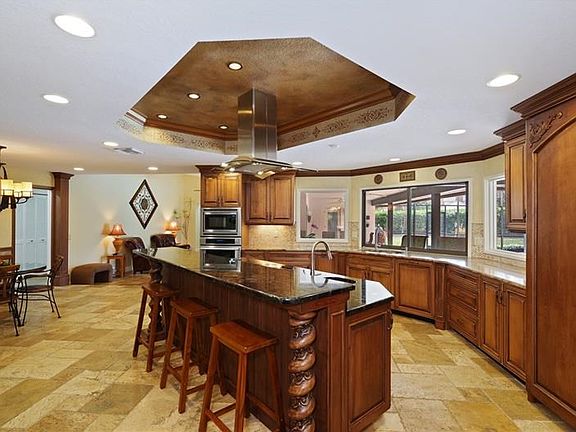 Open Stately Kitchen with Custom Cabinetry, Cooking Island with Breakfast Bar and Kitchen Dining Nook.