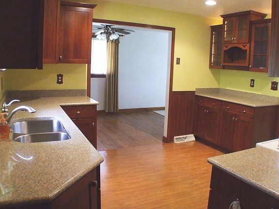 The deluxe kitchen features quartz counters and recessed lighting