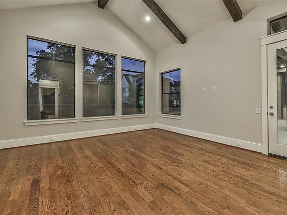 Vaulted-ceilings in the first-floor master bedroom with private access to the outdoor patio and beautiful windows overlooking the backyard.