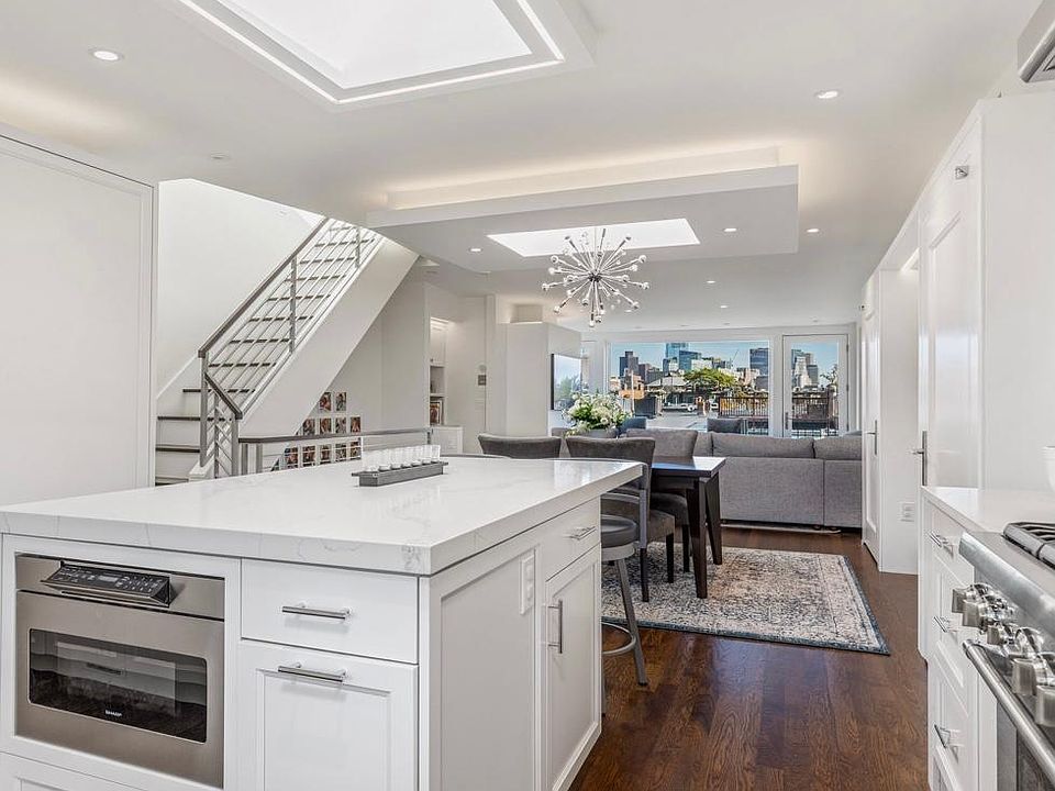 Kitchen looking towards living room with 3 skylights