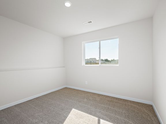 The master bedroom is spacious with a larger window.