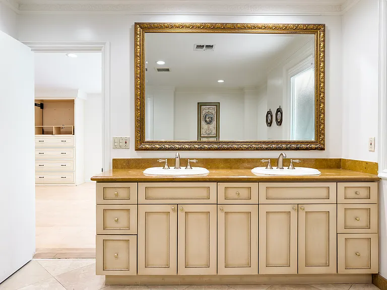 Elegant double vanity with a gold-framed mirror and dual sinks elevates this bathroom in a Beverly Hills luxury rental at 1094 Garden Lane, 90210.