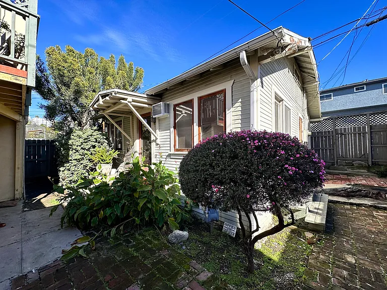 Cottage and side yard (front gate not shown)