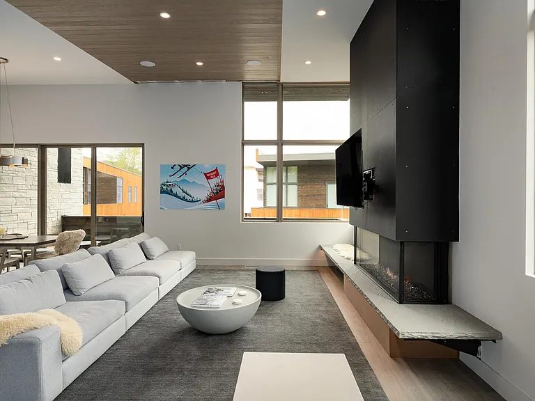 Huge gas fireplace with stone seating and large flat screen TV.