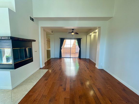Open floor plan living and dining room. Vaulted ceiling and fireplace