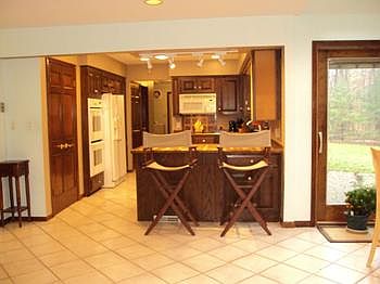 The kitchen appliances are included. There is a sliding glass door to the patio off the dining area.