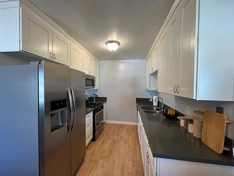 Please note: Pre-renovation photo shown for layout reference. Brand-new flooring has since been installed.