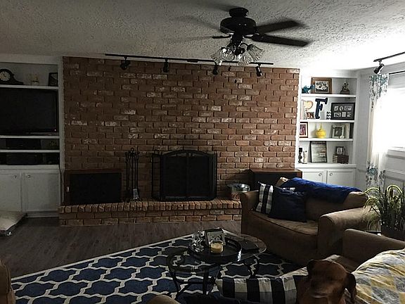 Large Family Room with an exceptionally large hearth with built-ins on either side.