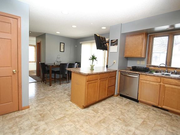 Spacious kitchen with eat-in area leading to sliding door onto spacious freshly finished deck.