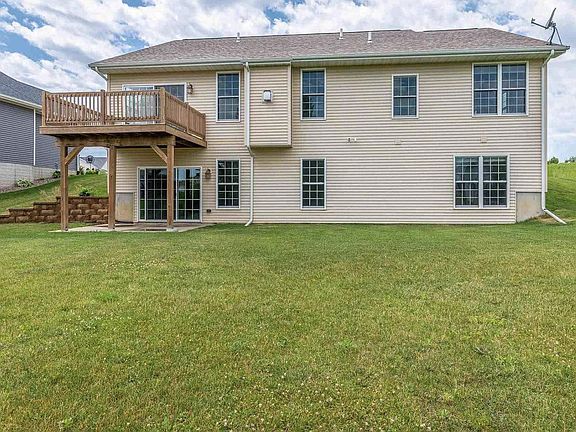 Back of home with deck and patio below.