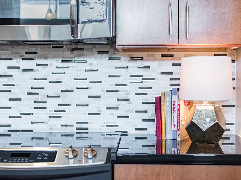 Kitchens with stainless steel appliances and tile backsplash