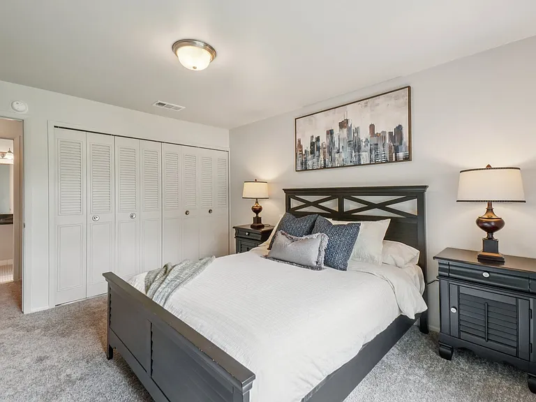 Cozy bedroom with ample storage space at Drawbridge Apartments in Harrison Township, MI.