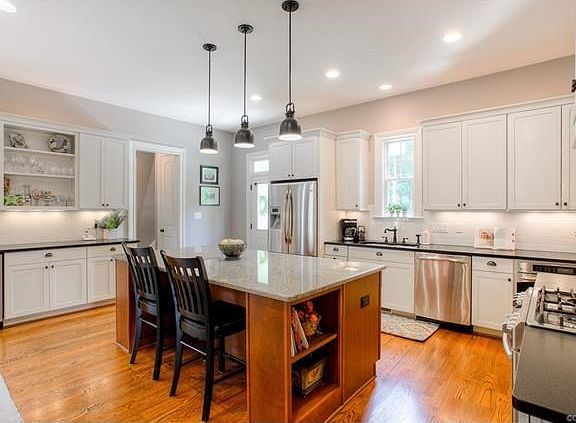 Open kitchen, rear stair access to family room over garage and powder room