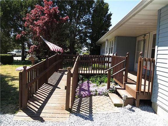 Handicap ramp and stairs lead to the home